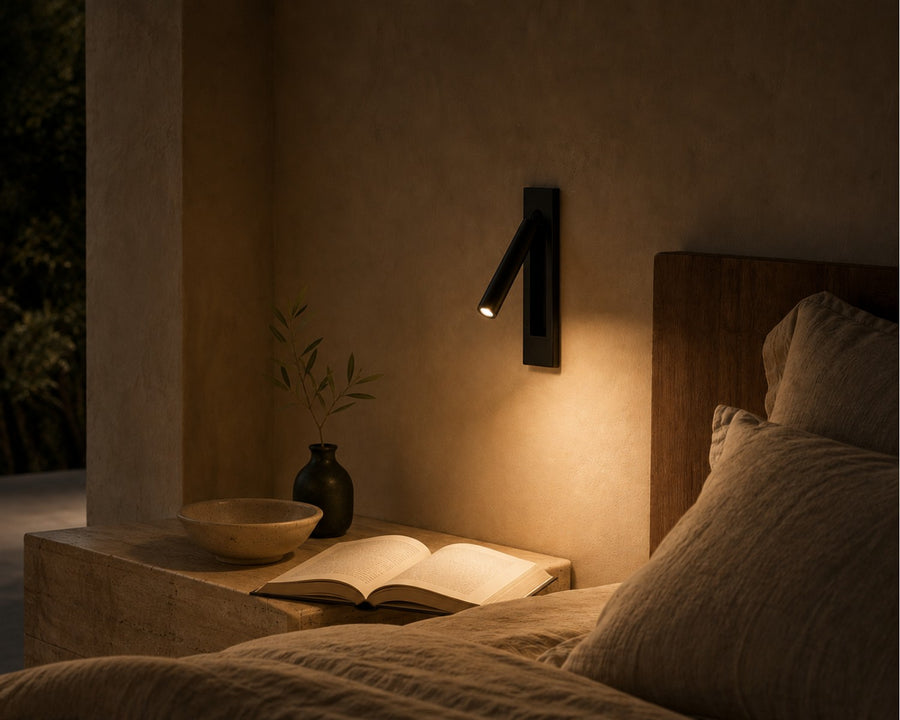 The sconce pulled out and lit over a nightstand