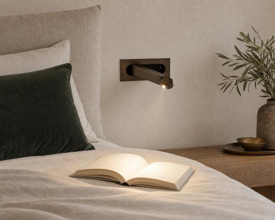 The sconce arm folded and extended to aim the light