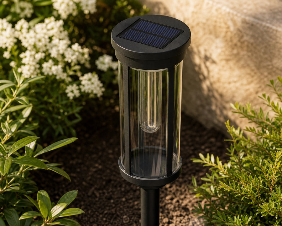 The solar panel on top of the stake light in daylight