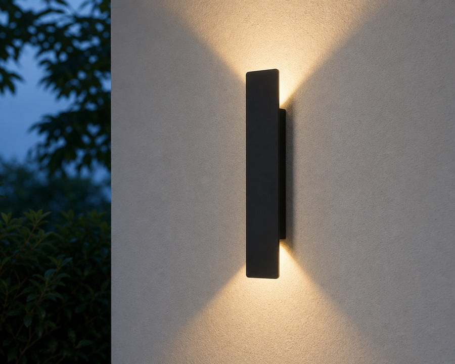 The wall light casting a soft up-and-down glow
