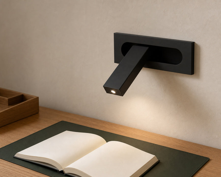 The sconce casting a focused reading light