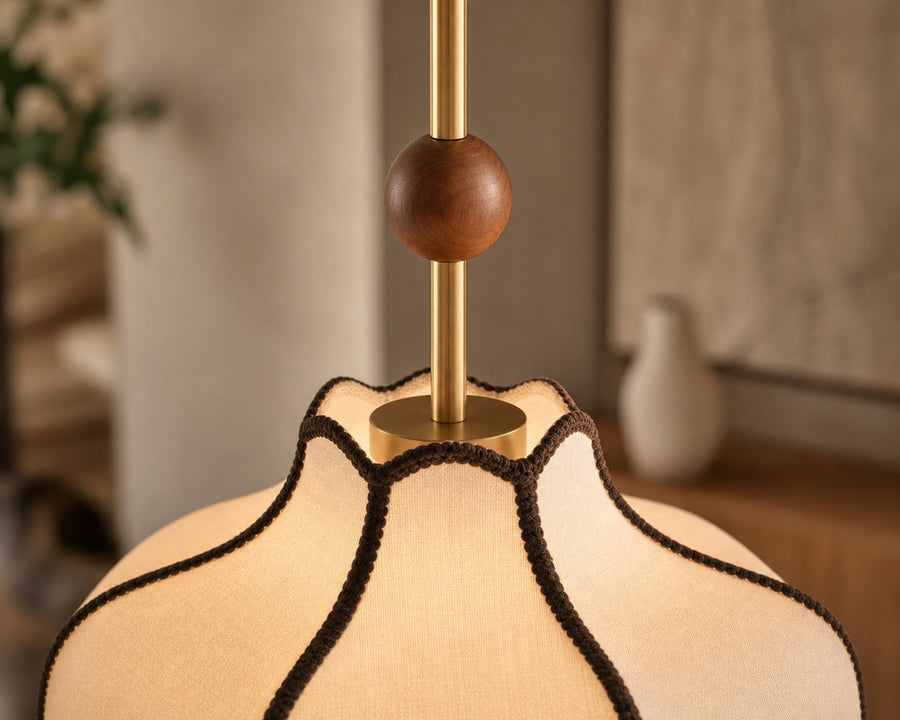 The walnut and brass detailing above the shade