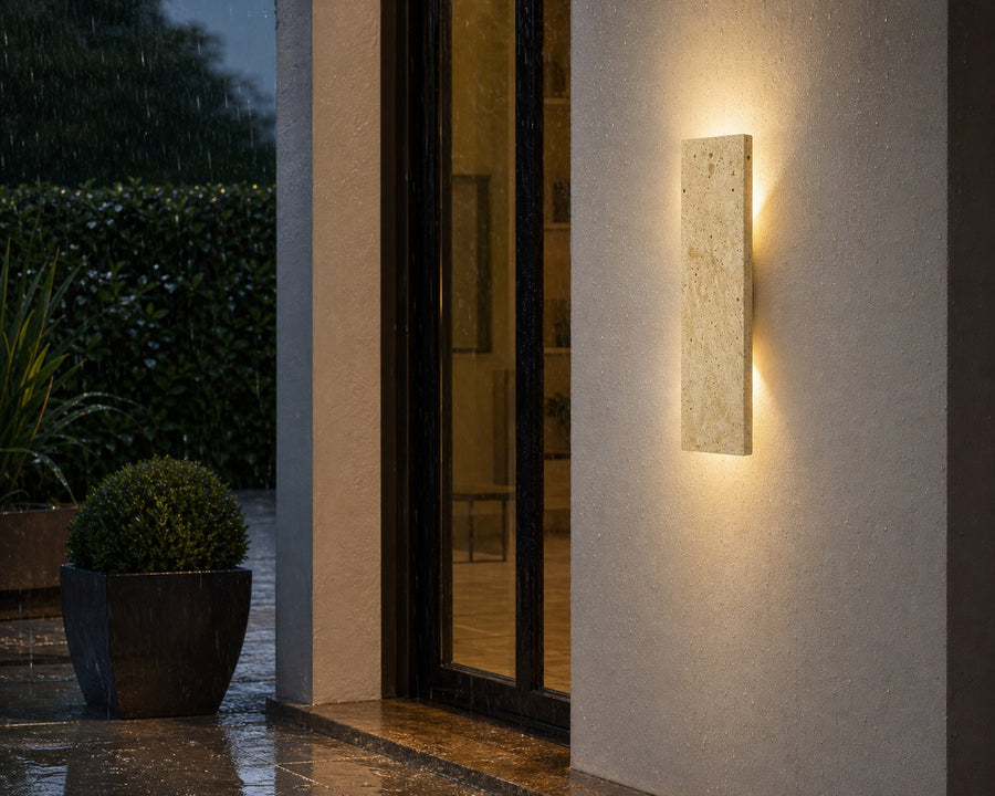 The sconce mounted by an exterior door in the rain