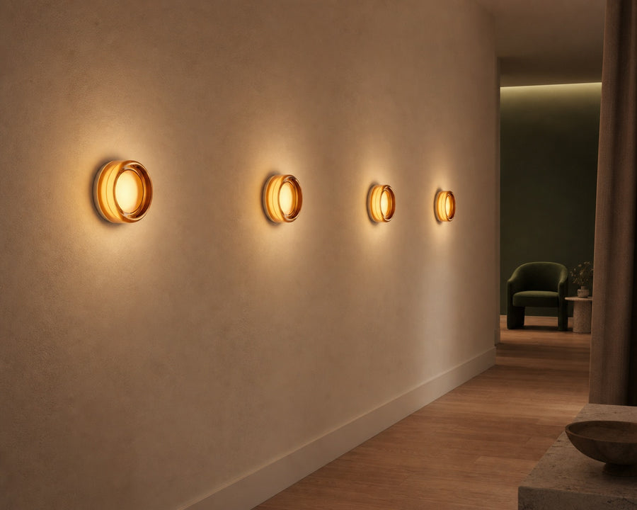 A row of Rondel sconces glowing warm along a hallway