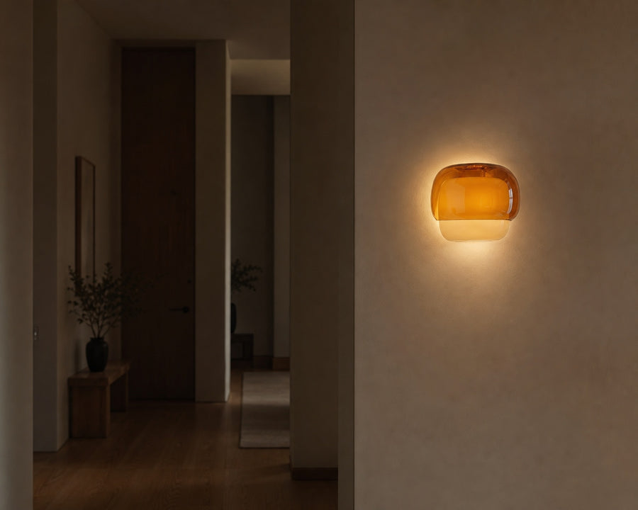 The sconce lit softly in a dim hallway
