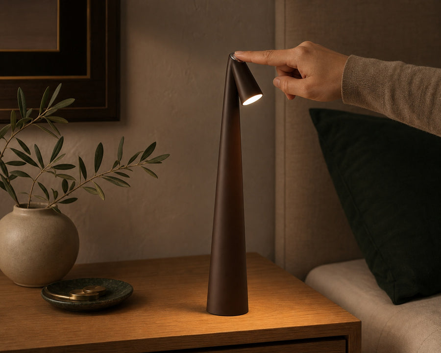A hand touching the lamp to dim it
